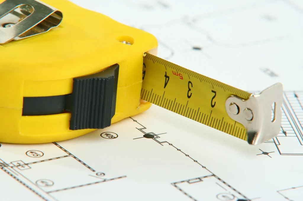 a picture of a measuring Tape on a blueprint